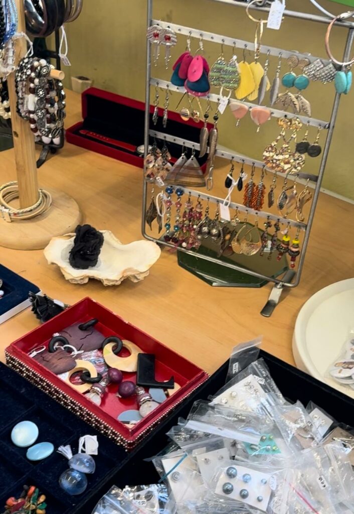 A shelf with different earrings and jewellery.