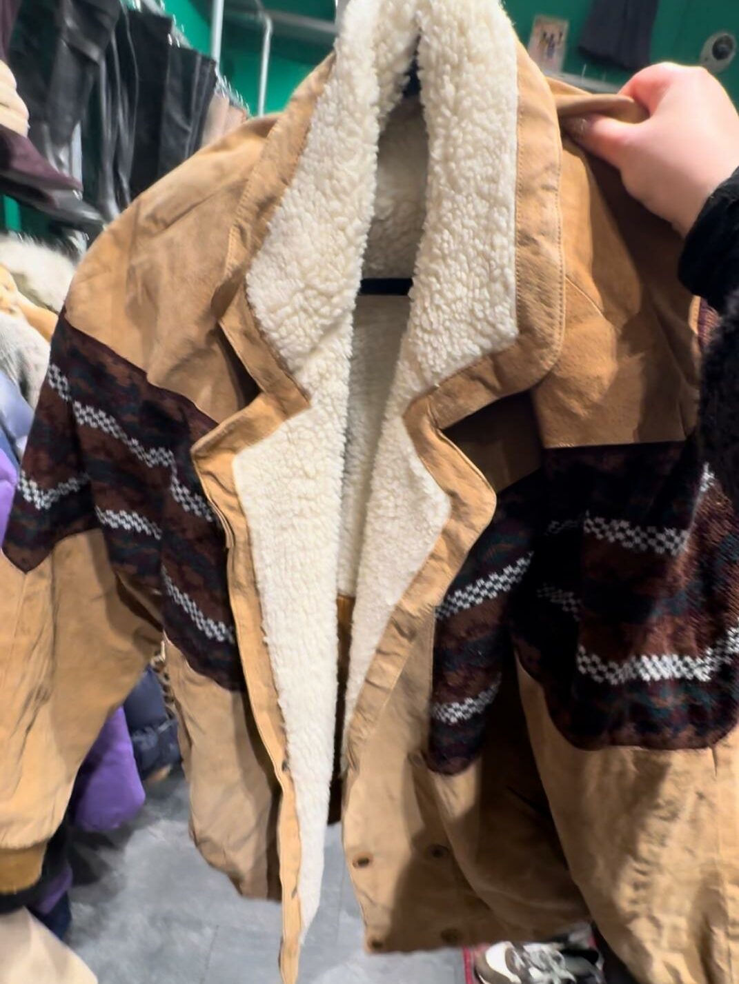 A beige-brown jacket made out of wool. 